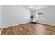 Bright, airy bedroom with natural light, wood-look flooring, and a comfortable chair by the window at 1773 Hallandale Ln, The Villages, FL 32162