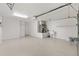 Spacious garage with epoxy floor, utility sink, and storage space for vehicles and equipment at 1773 Hallandale Ln, The Villages, FL 32162