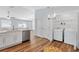 Open concept area features a kitchen with stainless appliances and a laundry closet with a white washer and dryer at 1773 Hallandale Ln, The Villages, FL 32162
