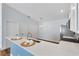 Open kitchen features a breakfast bar with white countertop, stylish faucet, and stainless steel appliances, creating a welcoming space at 1773 Hallandale Ln, The Villages, FL 32162