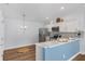 Bright kitchen boasts stainless steel appliances, white cabinetry, and a stylish breakfast bar for casual dining at 1773 Hallandale Ln, The Villages, FL 32162