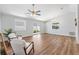 Open-concept living room boasting wood floors, natural light, and seamless access to the outdoor patio at 1773 Hallandale Ln, The Villages, FL 32162