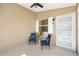 Cozy screened patio features comfortable seating, ceiling fan, and access to the outdoors at 1773 Hallandale Ln, The Villages, FL 32162