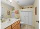 Bathroom featuring warm wood cabinets, a white toilet, and decorative closet doors at 17883 Se 125Th Cir, Summerfield, FL 34491