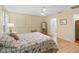 Bedroom features an ensuite bathroom, hardwood flooring and neutral-toned walls at 17883 Se 125Th Cir, Summerfield, FL 34491