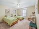 Charming bedroom with two twin beds, a ceiling fan, and a carpeted floor at 17883 Se 125Th Cir, Summerfield, FL 34491