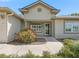 The front entrance has an attractive doorway, well-maintained landscaping, and a freshly painted exterior at 17883 Se 125Th Cir, Summerfield, FL 34491