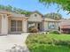 Home exterior featuring a well-manicured front yard with lush landscaping and inviting curb appeal at 17883 Se 125Th Cir, Summerfield, FL 34491