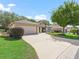 Charming single-story home with a well-manicured lawn, a mature tree, and an inviting driveway at 17883 Se 125Th Cir, Summerfield, FL 34491
