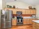 Kitchen showcases stainless steel appliances, wooden cabinets, and decor above the cabinets at 17883 Se 125Th Cir, Summerfield, FL 34491