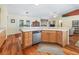 Kitchen view with natural light, hardwood floors, and an open design leading into the living spaces at 17883 Se 125Th Cir, Summerfield, FL 34491