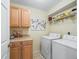 Well-equipped laundry area with washer, dryer, storage cabinets, and countertop space at 17883 Se 125Th Cir, Summerfield, FL 34491