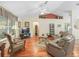 Comfortable living room with hardwood floors, a vaulted ceiling, and a view of the entryway at 17883 Se 125Th Cir, Summerfield, FL 34491