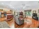 Open-concept living room with hardwood floors, and views of the kitchen and dining area at 17883 Se 125Th Cir, Summerfield, FL 34491
