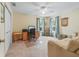 Bright office space featuring a ceiling fan, natural light, and neutral walls and carpets at 17883 Se 125Th Cir, Summerfield, FL 34491