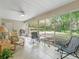 Cozy sunroom with tile flooring, ceiling fan, and views of the serene backyard at 17883 Se 125Th Cir, Summerfield, FL 34491