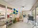 Bright sunroom with tile floor, ceiling fan, and multiple windows creating a relaxing space at 17883 Se 125Th Cir, Summerfield, FL 34491