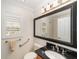 Bathroom with granite countertop, large mirror, and modern fixtures at 1907 Anderson Ct, The Villages, FL 32162