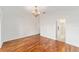 Bright bedroom with hardwood floors, decorative light fixture and en suite bathroom at 1907 Anderson Ct, The Villages, FL 32162