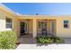 Inviting front porch with decorative accents and a well-manicured garden at 1907 Anderson Ct, The Villages, FL 32162