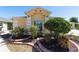 Landscaped front yard featuring tropical plants and colorful flowers near the entrance at 1907 Anderson Ct, The Villages, FL 32162
