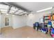 Garage featuring epoxy floors, convenient storage, and both interior and exterior access at 1907 Anderson Ct, The Villages, FL 32162