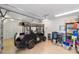 Garage includes epoxy flooring, storage shelves, and a golf cart for leisure at 1907 Anderson Ct, The Villages, FL 32162