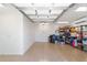Spacious garage featuring epoxy floors and ample shelving for storage solutions at 1907 Anderson Ct, The Villages, FL 32162