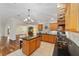 Well-equipped kitchen with granite countertops and stone accents, seamlessly blending with the living space at 1907 Anderson Ct, The Villages, FL 32162