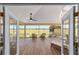 Screened in lanai with ceiling fan, comfortable seating, and a view of the golf course at 1907 Anderson Ct, The Villages, FL 32162