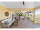 Spacious screened lanai with comfortable seating arrangements and view of golf course at 1907 Anderson Ct, The Villages, FL 32162