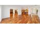 Open concept living space with hardwood floors, natural light, and views into other living areas at 1907 Anderson Ct, The Villages, FL 32162