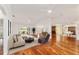 Bright open living room features hardwood floors, neutral walls and furniture, and a sliding door to the patio at 1907 Anderson Ct, The Villages, FL 32162