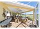 Inviting outdoor patio with dining and seating areas, offering picturesque views of the golf course at 1907 Anderson Ct, The Villages, FL 32162