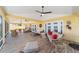 Spacious screened patio with comfortable seating areas and ceiling fans, perfect for enjoying the outdoors at 1907 Anderson Ct, The Villages, FL 32162