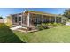 Enjoy the outdoors bug free in the spacious screened lanai overlooking landscaped yard at 1907 Anderson Ct, The Villages, FL 32162