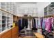 Organized walk-in closet with custom shelving, drawers, and hanging rods at 1907 Anderson Ct, The Villages, FL 32162