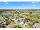 Aerial view of home nestled on golf course in a gated community at 2213 Evans Prairie Trl, The Villages, FL 32163