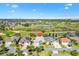 Aerial view of home with manicured lawn on a golf course in a gated community at 2213 Evans Prairie Trl, The Villages, FL 32163