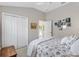 Bright bedroom featuring a closet, neutral walls, and coordinated bedding at 2213 Evans Prairie Trl, The Villages, FL 32163