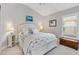 Cozy bedroom with plantation shutters, chest and white furniture creating a tranquil space at 2213 Evans Prairie Trl, The Villages, FL 32163