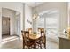 Bright dining area featuring tile flooring, wood table, and large windows with plantation shutters at 2213 Evans Prairie Trl, The Villages, FL 32163