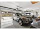 Well-lit three car garage with epoxy floors and ample storage and organization space at 2213 Evans Prairie Trl, The Villages, FL 32163