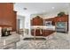 Modern kitchen featuring granite countertops, stainless steel appliances, and dark wood cabinetry at 2213 Evans Prairie Trl, The Villages, FL 32163