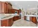 Elegant kitchen featuring granite countertops, stainless steel appliances, and custom cabinetry at 2213 Evans Prairie Trl, The Villages, FL 32163