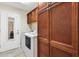 Laundry room featuring a washer, dryer, and storage at 2213 Evans Prairie Trl, The Villages, FL 32163