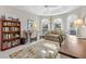 Sunroom-style office featuring a seating area, desk, bookcase, and outdoor view at 2213 Evans Prairie Trl, The Villages, FL 32163