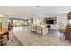 Spacious living room with tile flooring, built-in shelving, and access to the outdoor patio at 2213 Evans Prairie Trl, The Villages, FL 32163