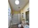 Bathroom showcasing a skylight, shower with curtain, vanity, toilet, and beige tiled floors at 2569 Errol Ter, The Villages, FL 32162