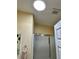 Bright bathroom featuring a skylight, glass shower door, and neutral-toned walls at 2569 Errol Ter, The Villages, FL 32162